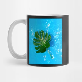 Monstera deliciosa plant floating on blue water Mug